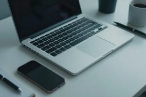 Always-on AI assistant workspace with a closed laptop and phone, illustrating Claude Duet