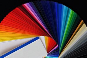 Fanned-out color swatches on a dark surface for Canva Craft