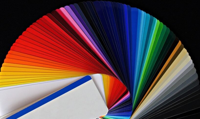 Fanned-out color swatches on a dark surface for Canva Craft