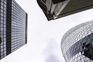Glass office towers against a bright sky for an OpenAI funding round story